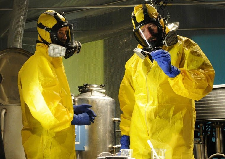 Jesse Pinkman (left) and Walter White (right) dressed in yellow PPE with respirators