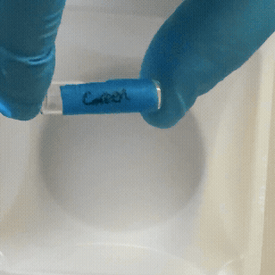 pouring acidified glow powder soltion into plastic tray